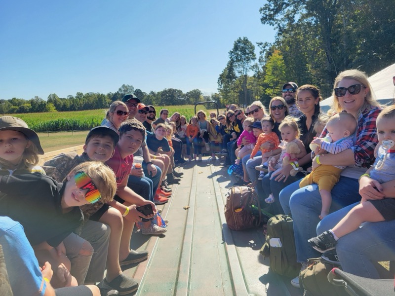 Burnsview families riding the hayride together at the Fall Family Festival