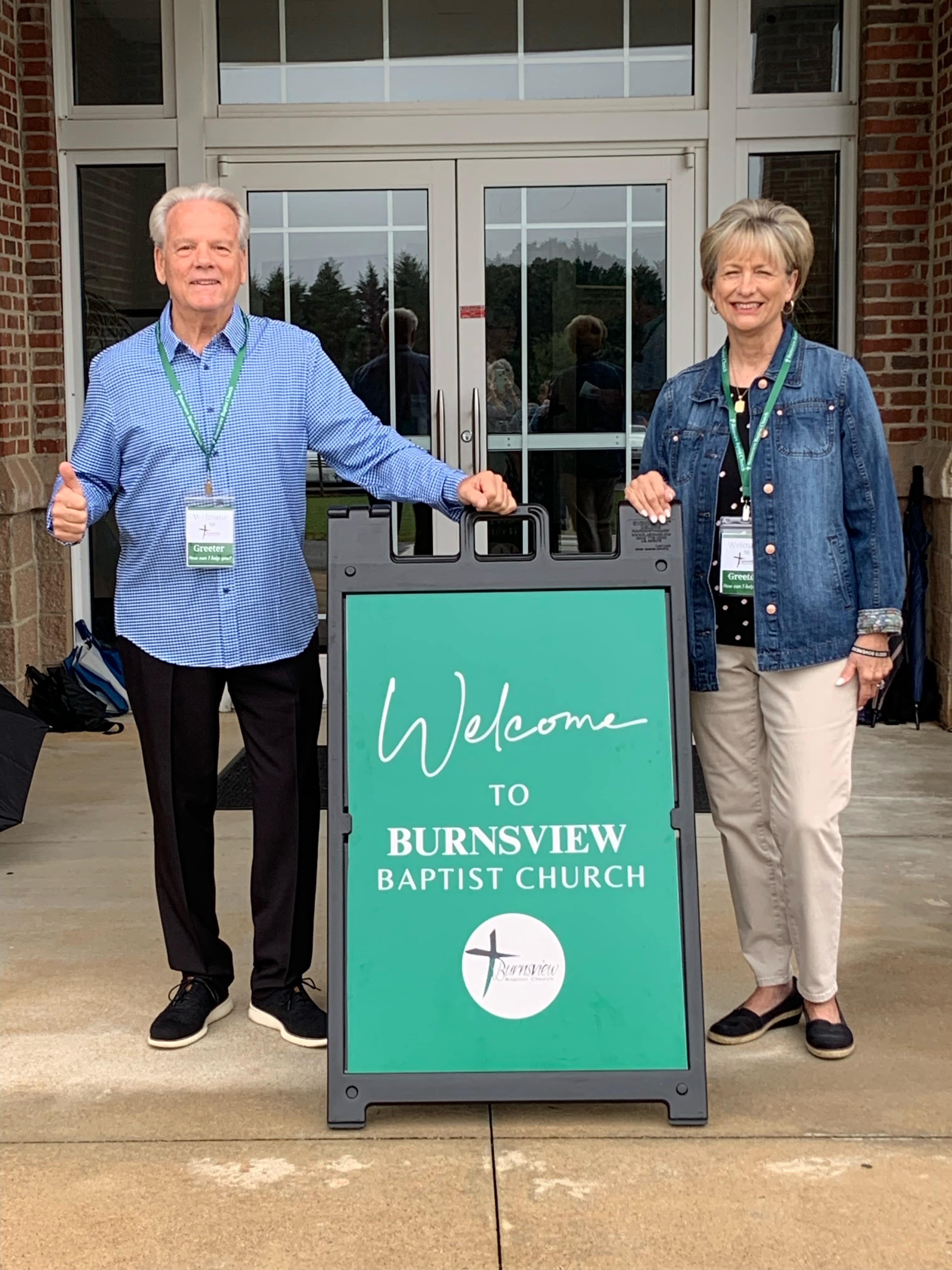Burnsview greeters welcoming guests at the front entrance